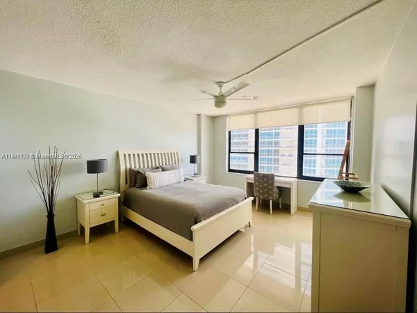 a spacious bedroom with a bed and a table