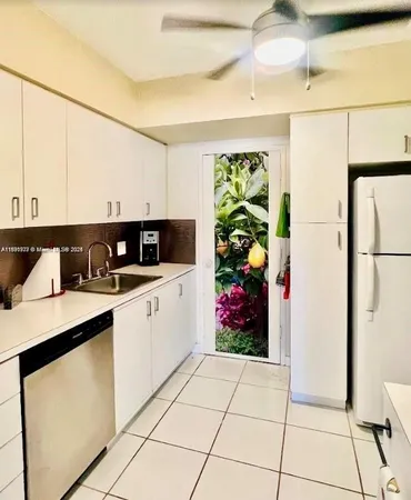 a kitchen with stainless steel appliances granite countertop a refrigerator sink and cabinets