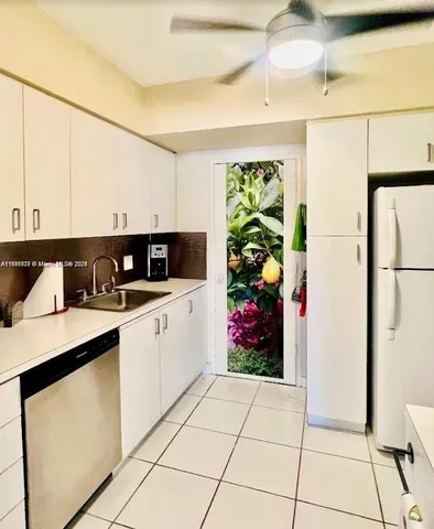 a kitchen with stainless steel appliances granite countertop a refrigerator sink and cabinets