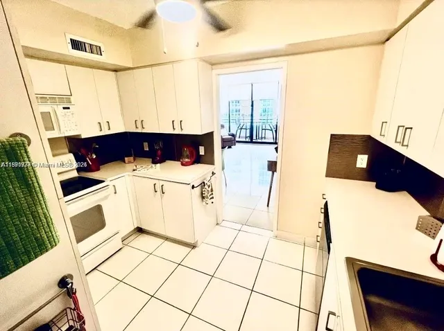 a view of a kitchen with a sink and microwave