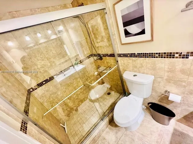 a white toilet sitting next to a bathroom sink