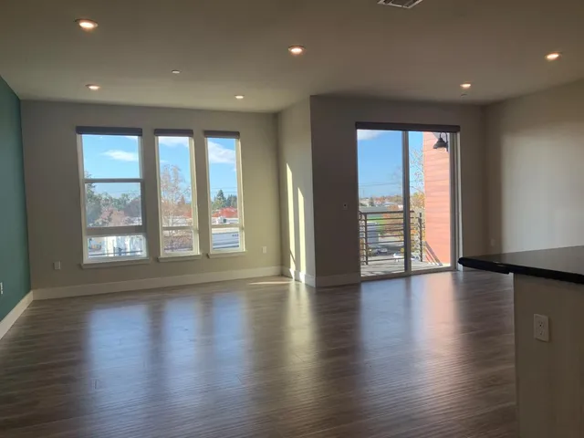 an empty room with wooden floor and a window