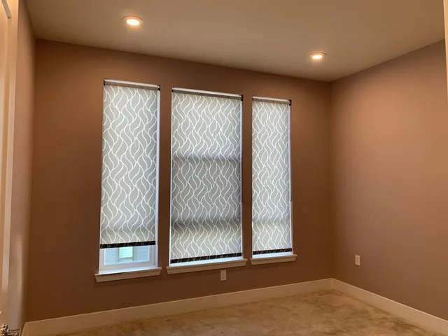 an empty room with windows and closet
