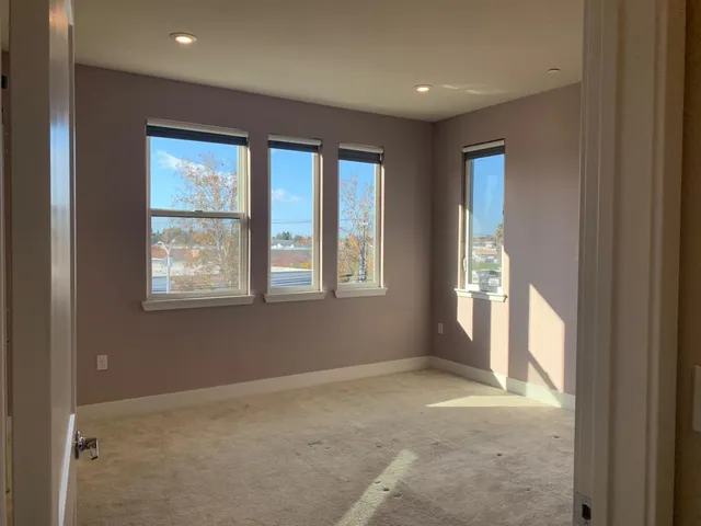 an empty room with closet and a bathroom