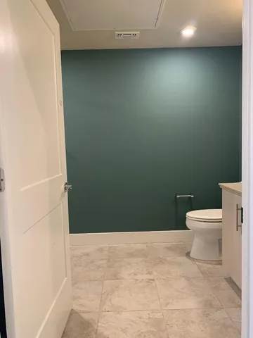 a bathroom with a shower and a glass door