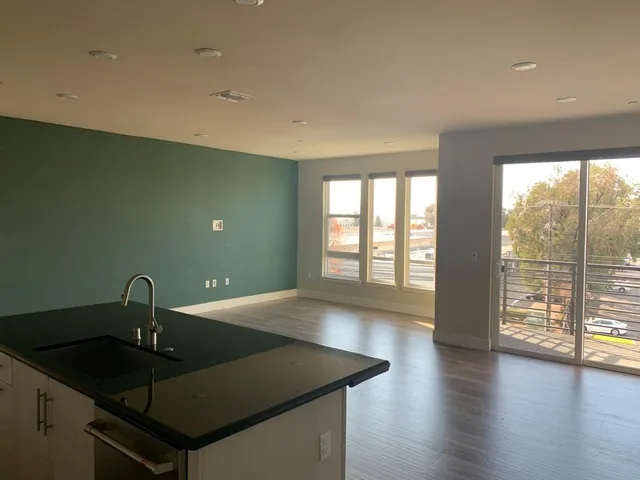 a kitchen with a sink and large window