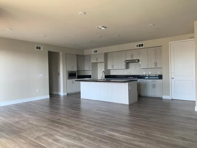 a view of kitchen with kitchen island microwave and stove