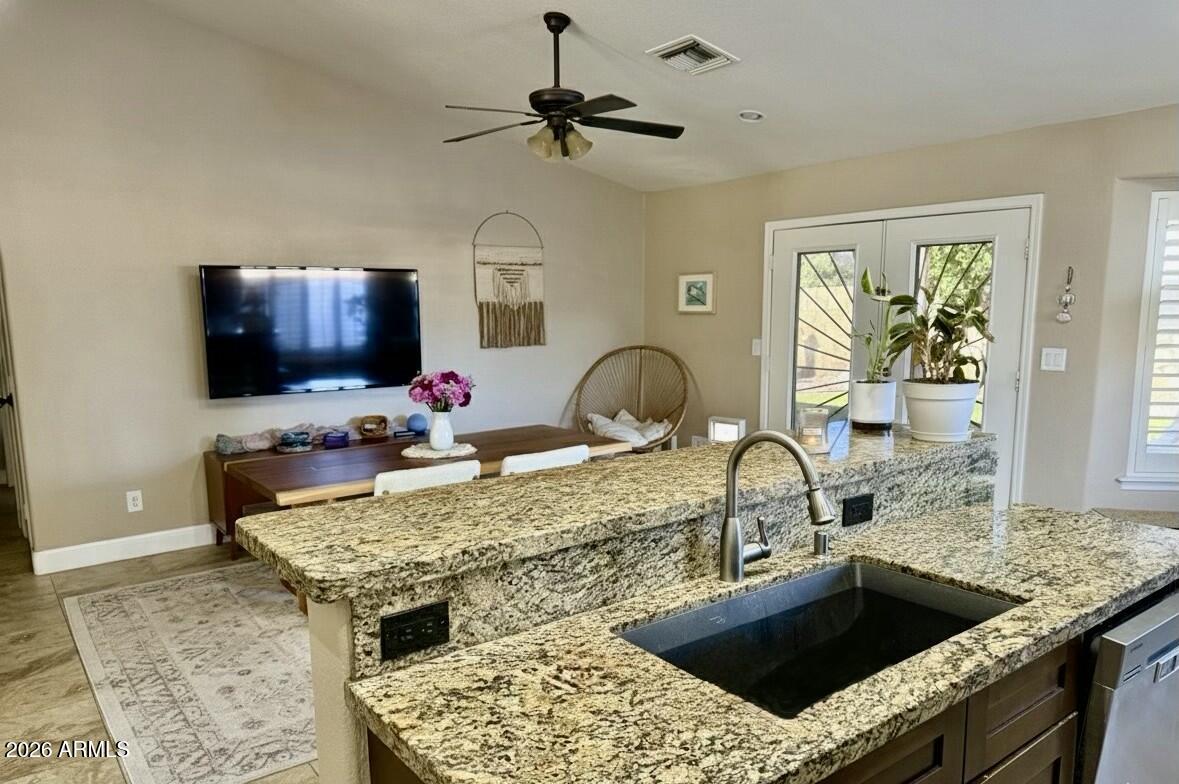 401 East Merrill Avenue Gilbert, AZ 85234 - Photo 13 of 21 a kitchen with a stove sink and a granite counter top