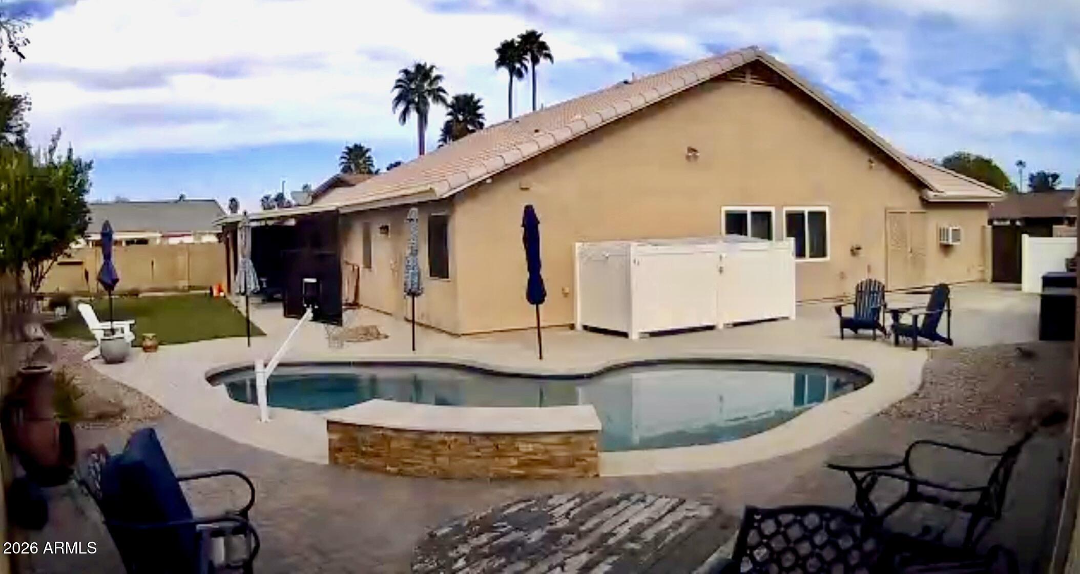 401 East Merrill Avenue Gilbert, AZ 85234 - Photo 14 of 21 a front view of a house with swimming pool having outdoor seating