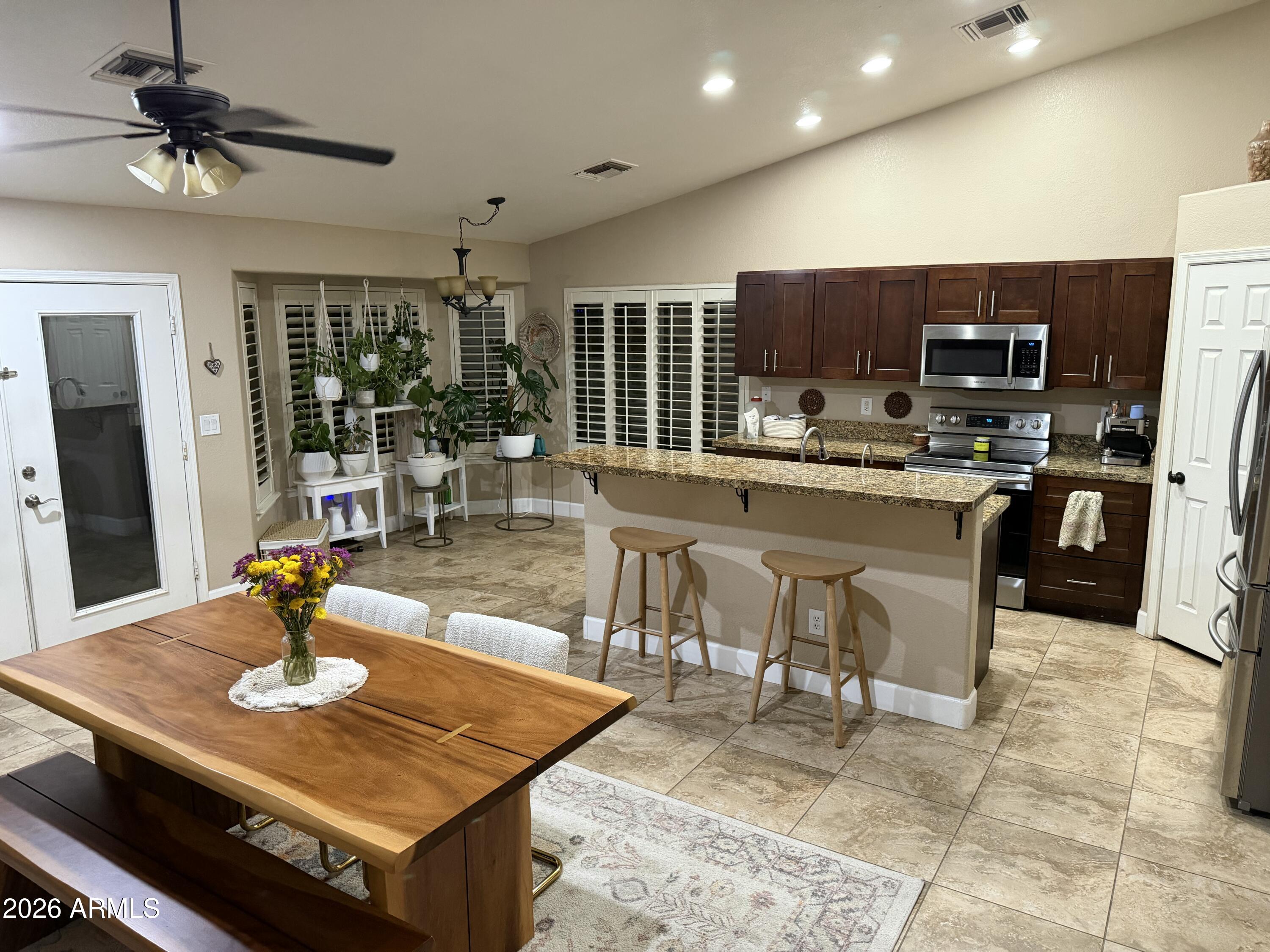 401 East Merrill Avenue Gilbert, AZ 85234 - Photo 2 of 21 a kitchen with a dining table and chairs
