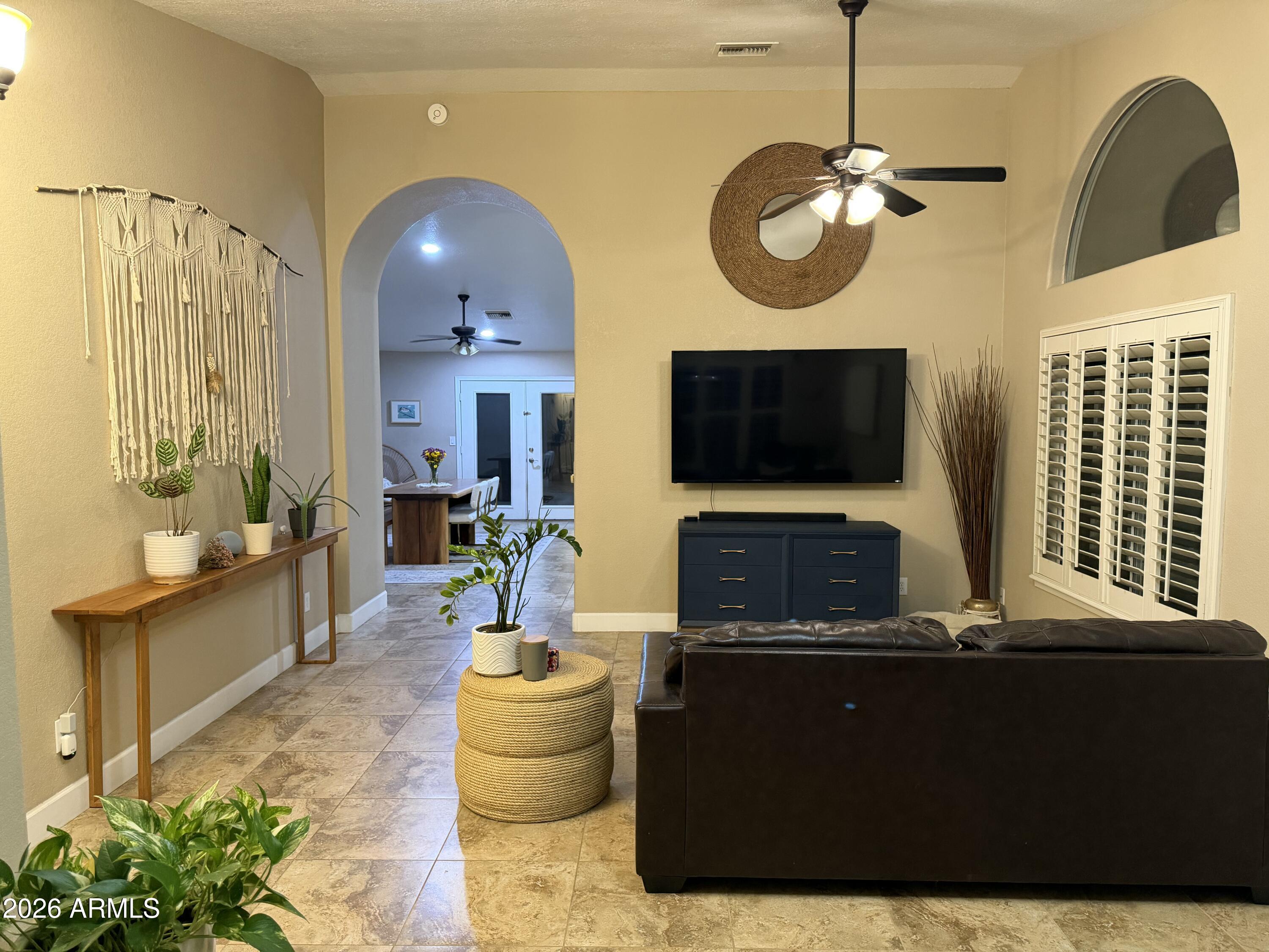 401 East Merrill Avenue Gilbert, AZ 85234 - Photo 5 of 21 a living room with fireplace furniture and a flat screen tv