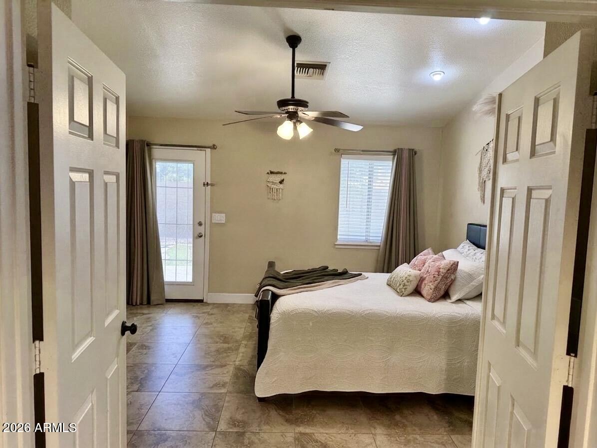 401 East Merrill Avenue Gilbert, AZ 85234 - Photo 6 of 21 a bedroom with a bed ceiling fan and a window