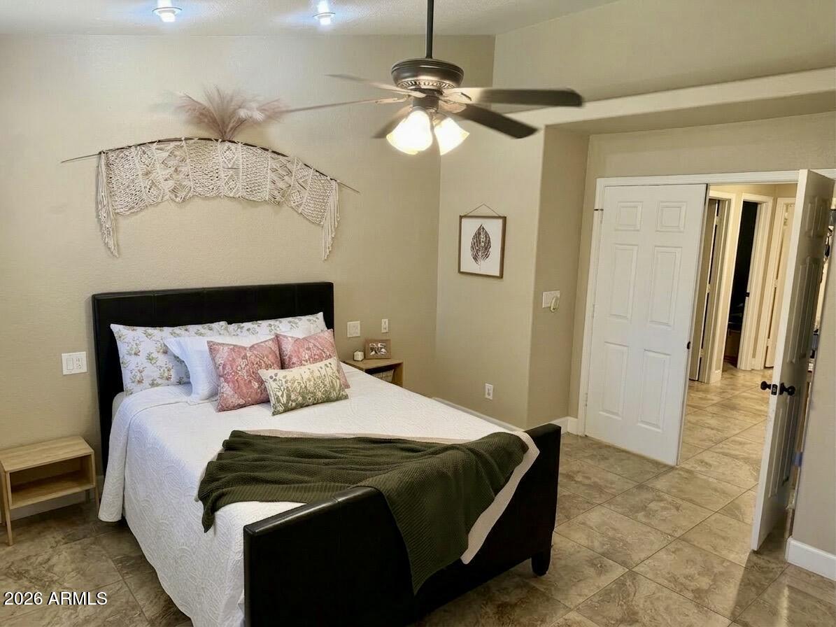 401 East Merrill Avenue Gilbert, AZ 85234 - Photo 7 of 21 a bedroom with a bed and a chandelier