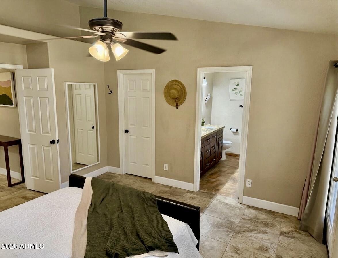 401 East Merrill Avenue Gilbert, AZ 85234 - Photo 8 of 21 a bedroom with a bed and a chandelier