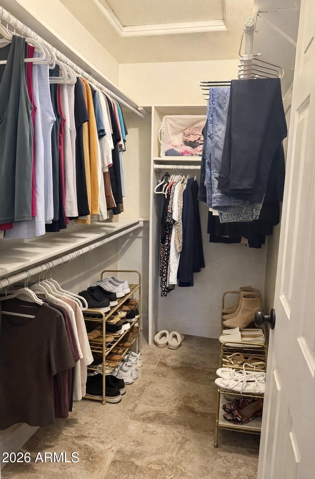 401 East Merrill Avenue Gilbert, AZ 85234 - Photo 10 of 21 a view of walk in closet with clothes and shoes