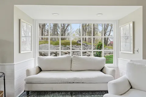 a bedroom with furniture and a flat screen tv