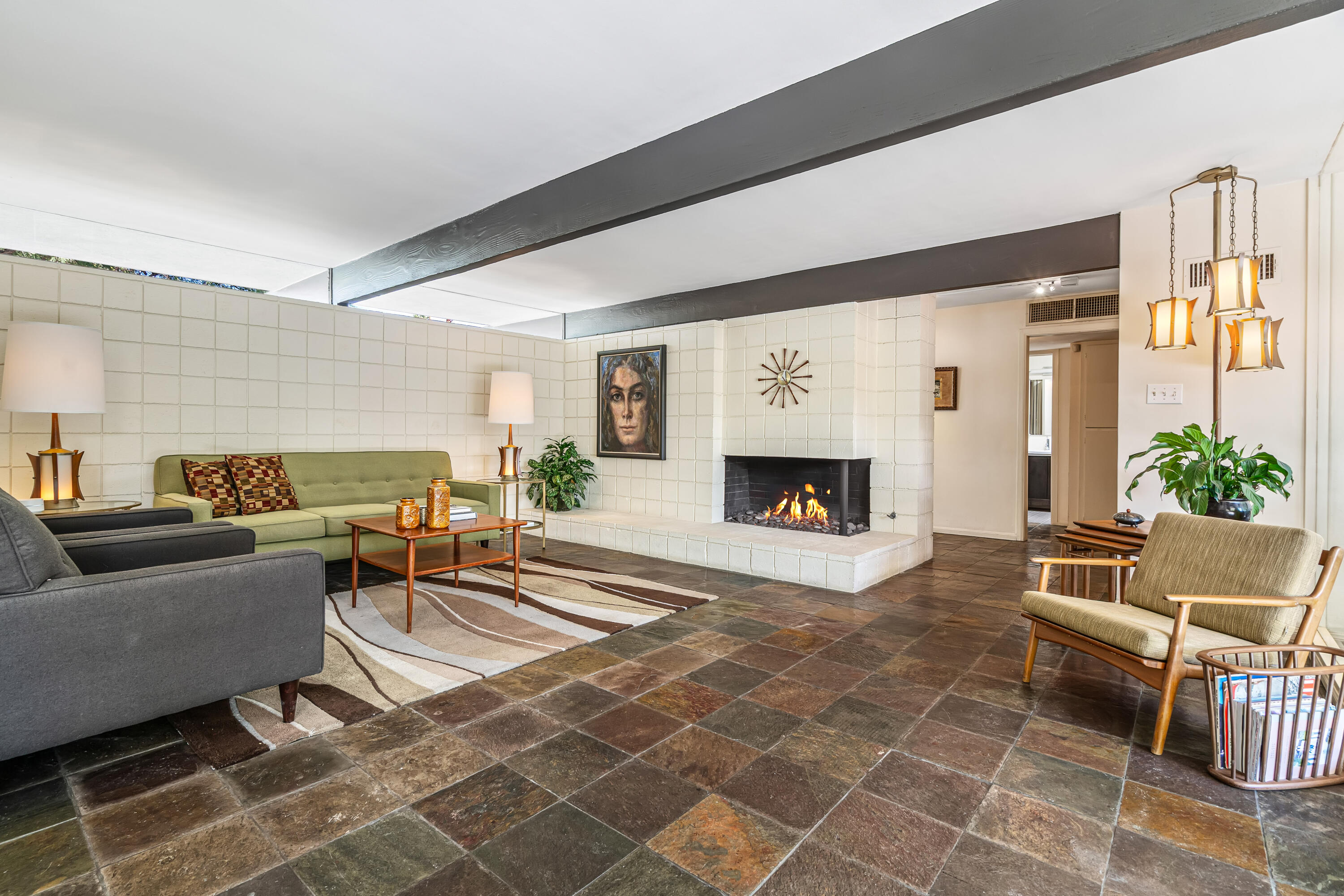 823 San Lucas Road Palm Springs, CA 92264 - Photo 14 of 71 a living room with furniture a fireplace and a flat screen tv