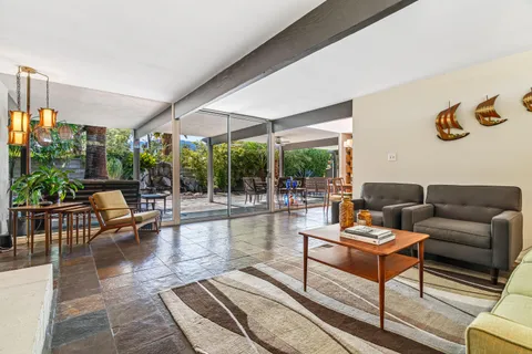 a kitchen with stainless steel appliances a sink a stove a refrigerator and cabinets