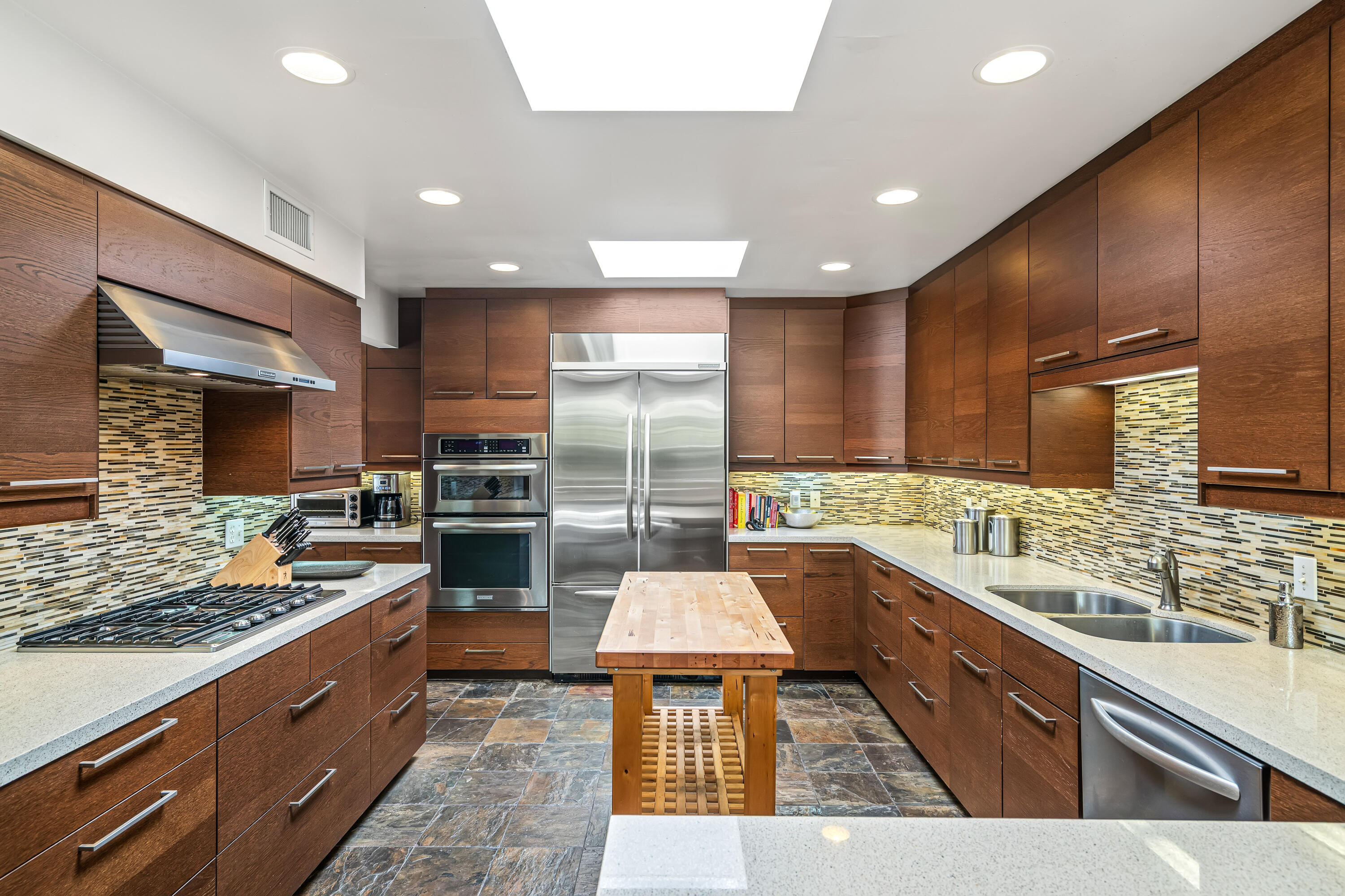 823 San Lucas Road Palm Springs, CA 92264 - Photo 21 of 71 a large kitchen with a large counter top stainless steel appliances and sink