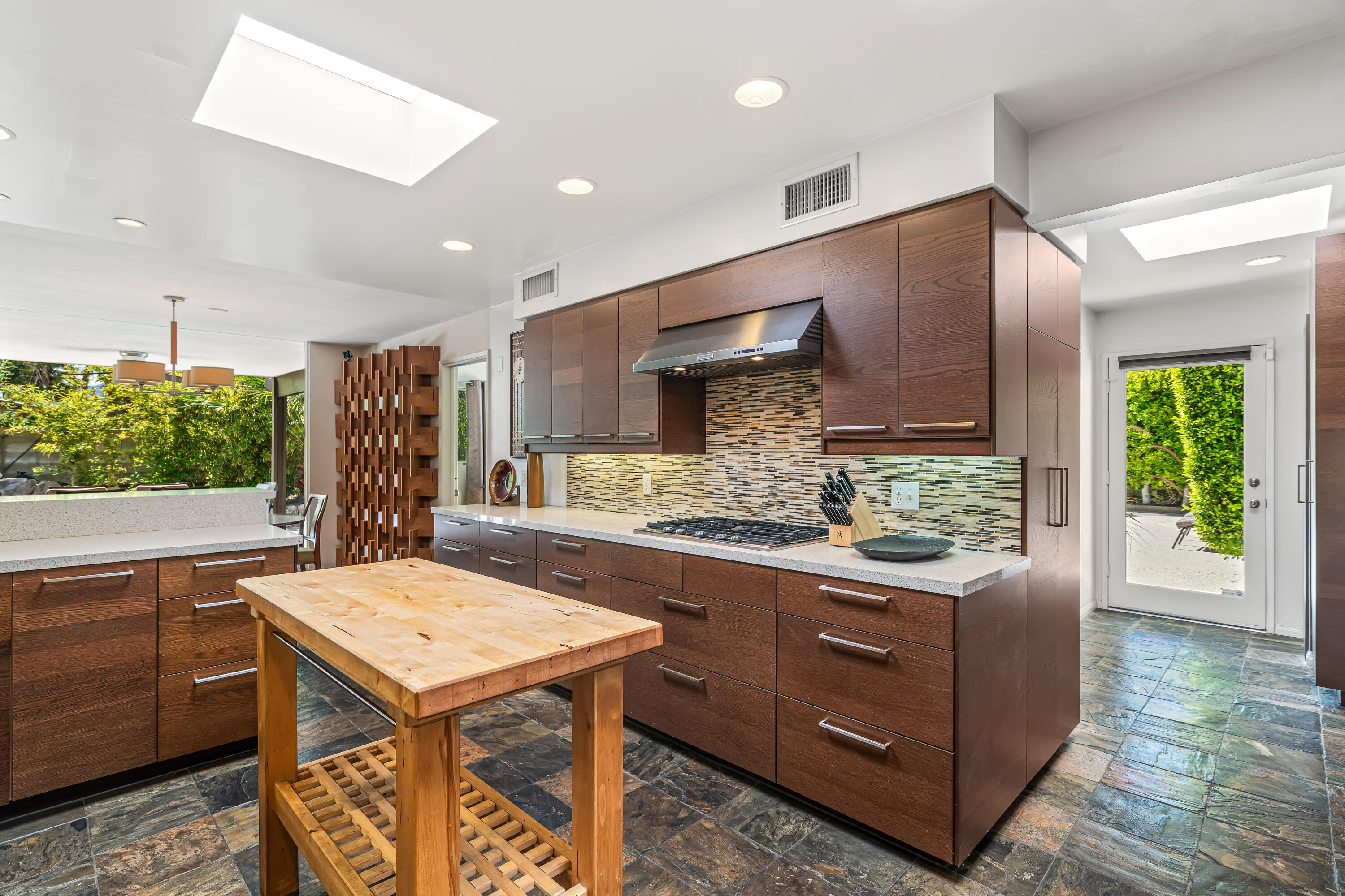 823 San Lucas Road Palm Springs, CA 92264 - Photo 24 of 71 a kitchen with a stove a refrigerator and a counter space