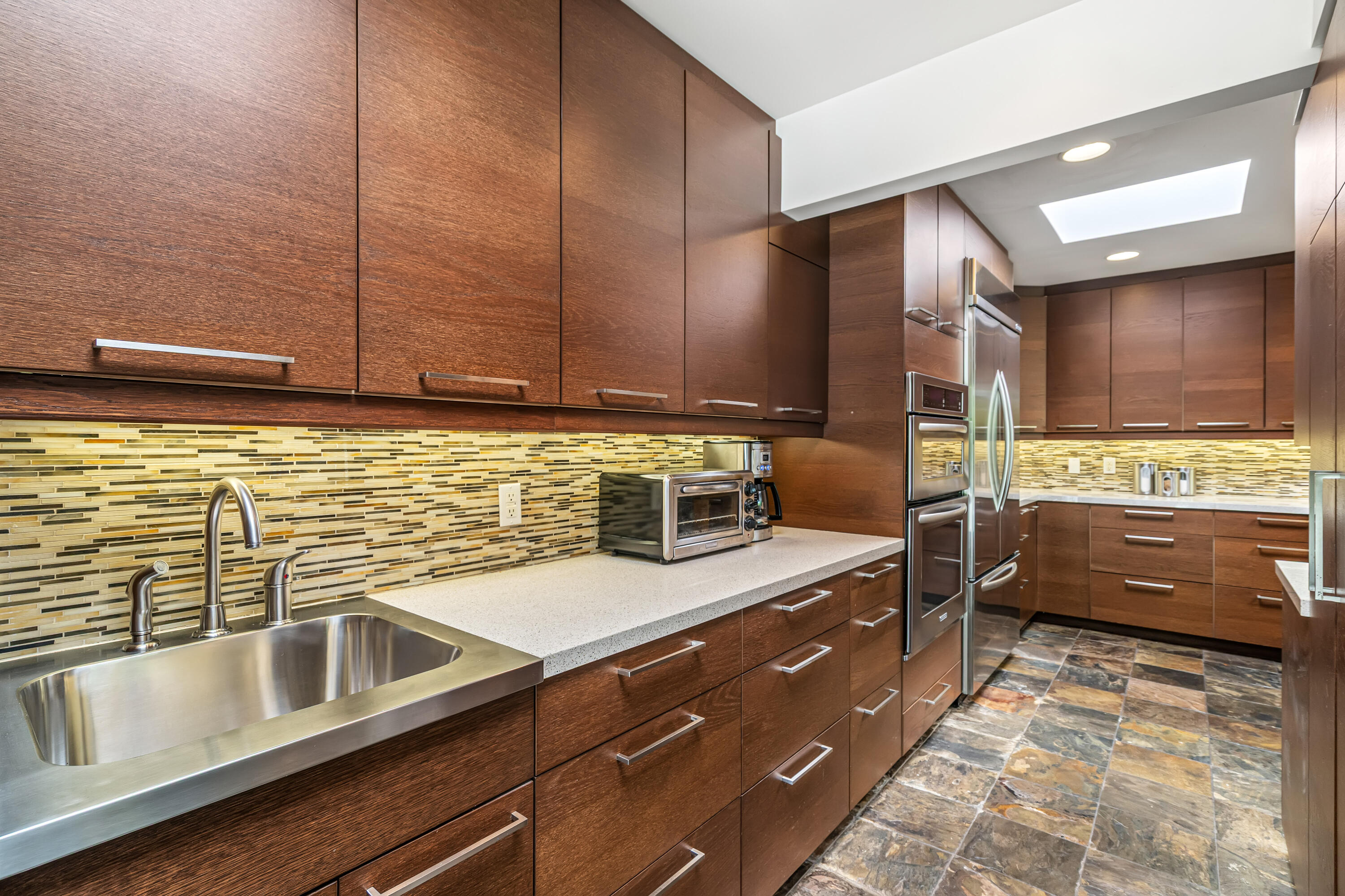 823 San Lucas Road Palm Springs, CA 92264 - Photo 25 of 71 a kitchen with stainless steel appliances a sink stove and cabinets