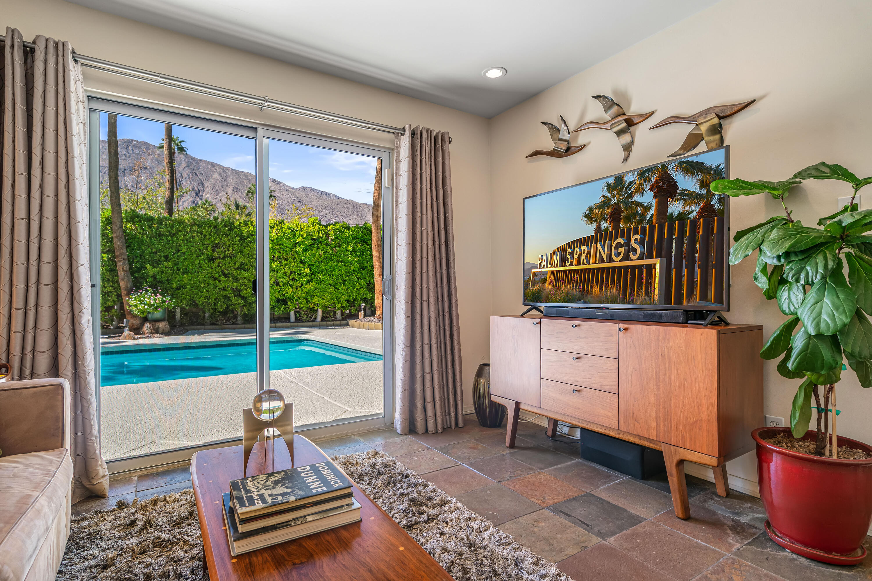 823 San Lucas Road Palm Springs, CA 92264 - Photo 27 of 71 a living room filled with furniture and a table