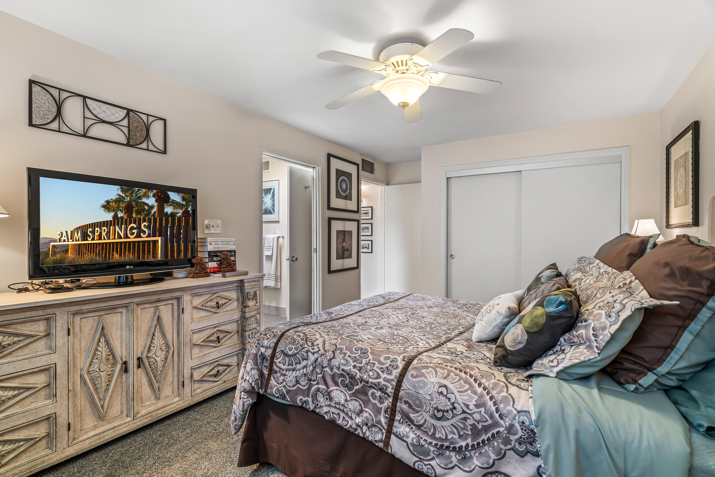 823 San Lucas Road Palm Springs, CA 92264 - Photo 32 of 71 a bedroom with a bed and a flat screen tv