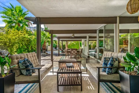 a backyard of a house with table and chairs