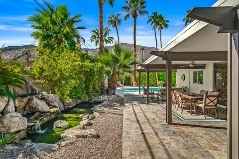 a view of a house with yard and sitting area