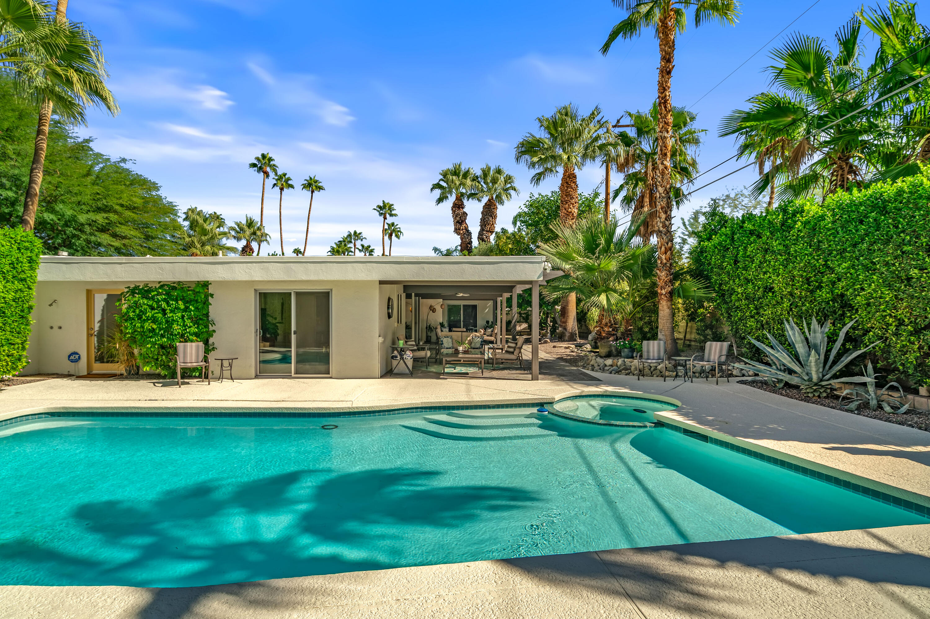823 San Lucas Road Palm Springs, CA 92264 - Photo 48 of 71 a front view of a house with a yard table and chairs