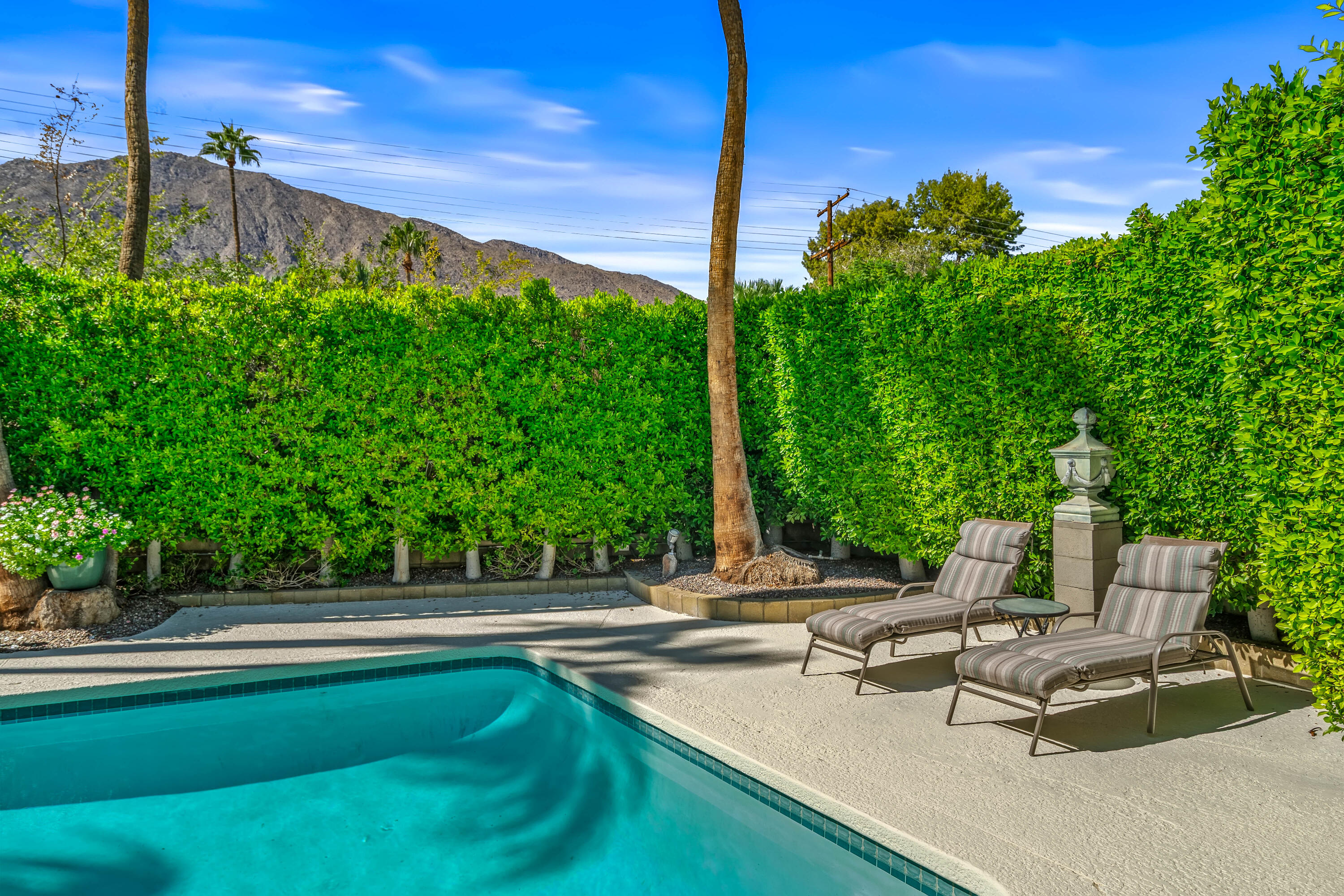 823 San Lucas Road Palm Springs, CA 92264 - Photo 49 of 71 a view of a patio with a table chairs and a fire pit