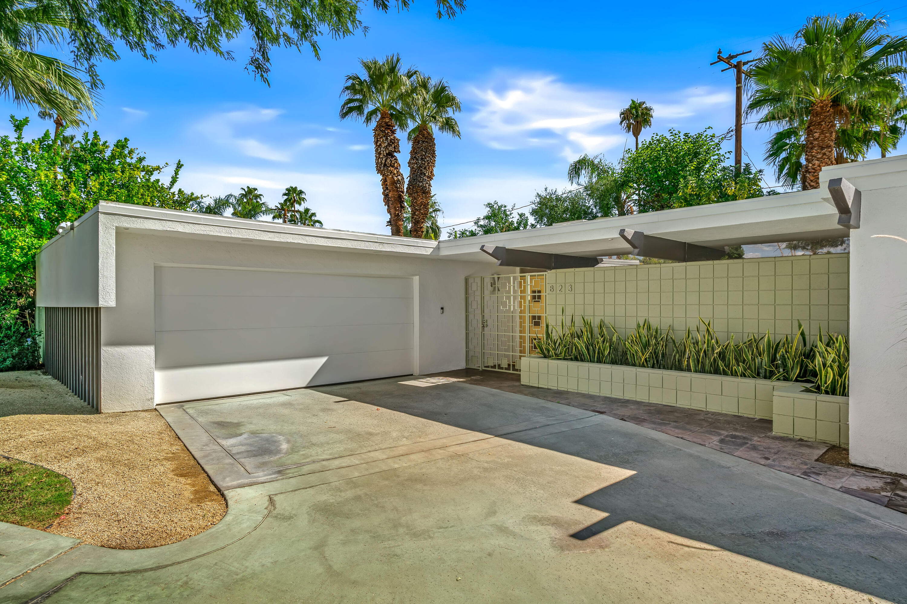 823 San Lucas Road Palm Springs, CA 92264 - Photo 6 of 71 a front view of a house with a yard and garage
