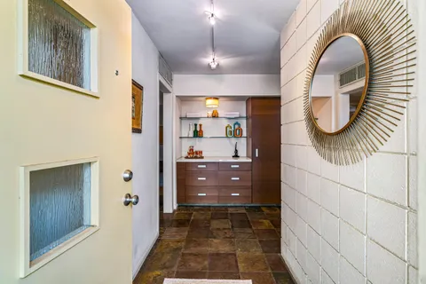 a living room with furniture a rug and a large window