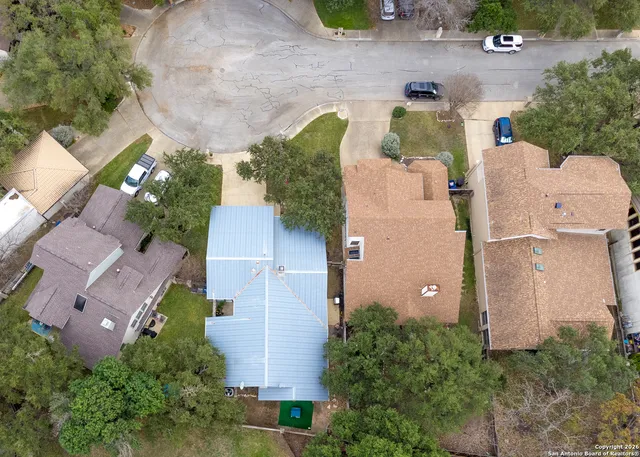 an aerial view of a house with yard and outdoor seating
