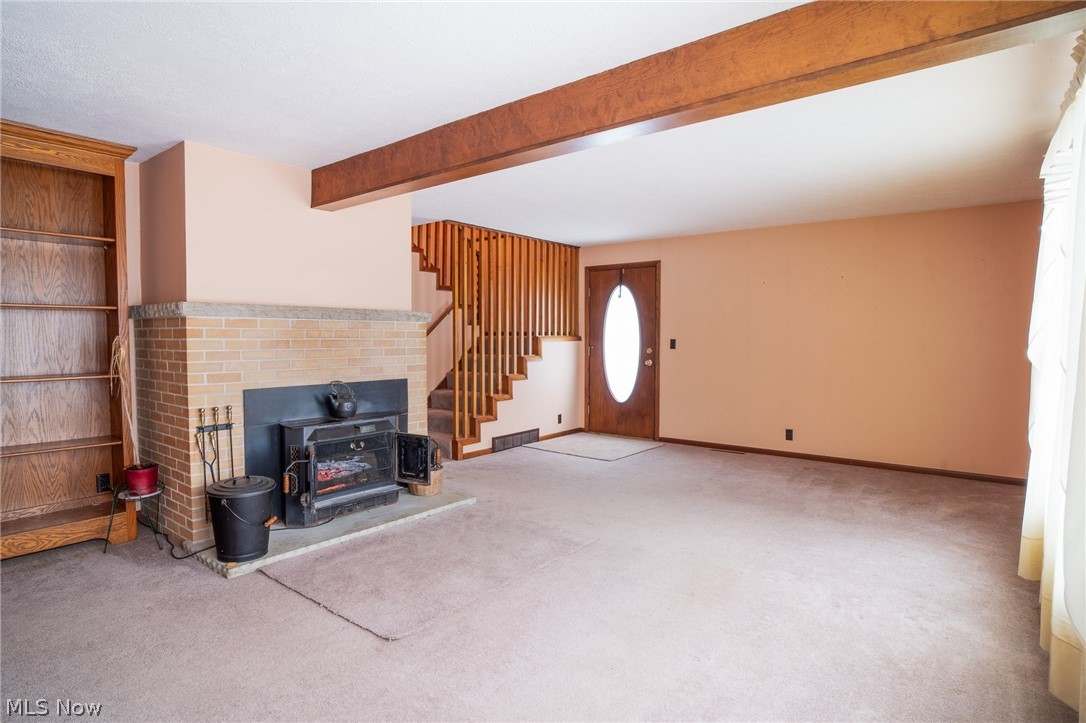 11 Pacific Road Northeast Carrollton, OH 44615 - Photo 19 of 46 Living room with wood burning stove, in use