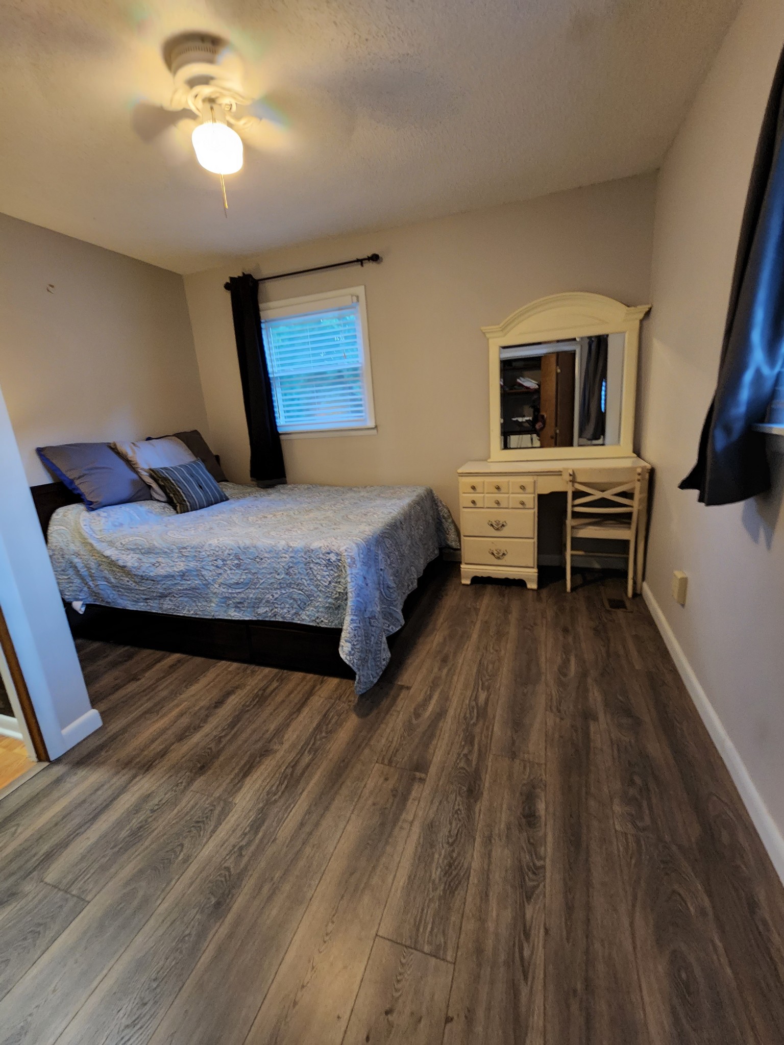 1075 West Point Road Lawrenceburg, TN 38464 - Photo 23 of 25 a bedroom with a bed and wooden floor