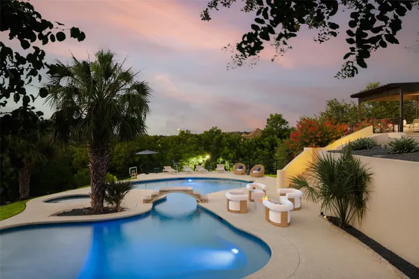 a view of a swimming pool with lounge chair