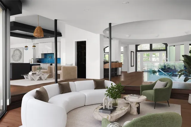 a living room with furniture kitchen view and a large window