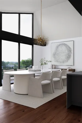 a living room with kitchen island furniture and floor to ceiling windows