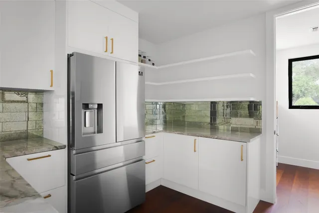 a kitchen with stainless steel appliances a refrigerator and a sink