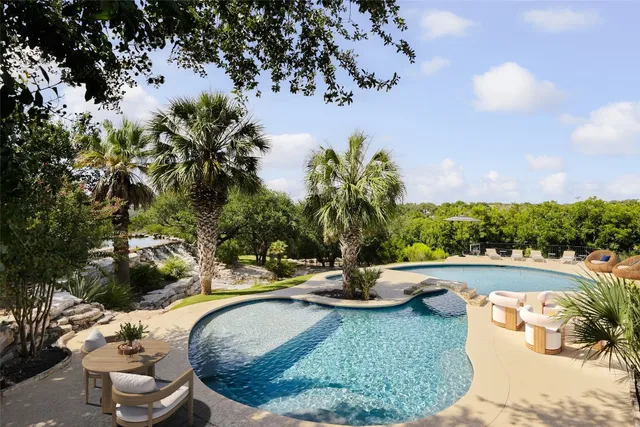 a view of a swimming pool with a yard