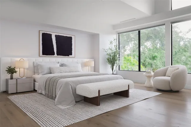 a bedroom with a large bed and a large window