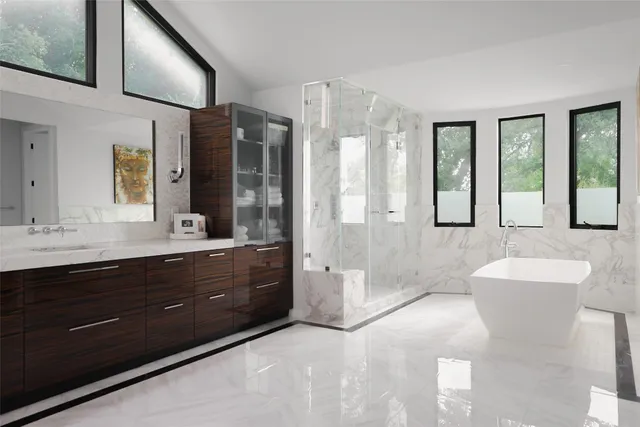 a spacious bathroom with a tub sink shower and mirror