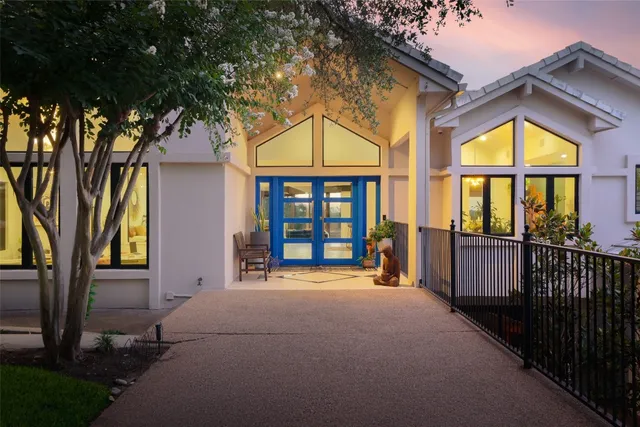 a view of swimming pool with a big yard and large tree