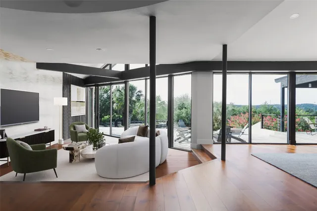 a living room with furniture and large windows