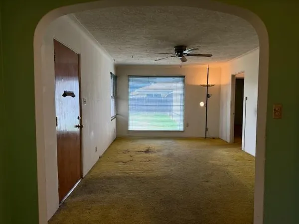 a view of an empty room and a window