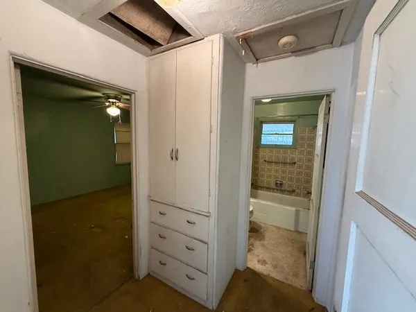 a bathroom with a toilet and a tub