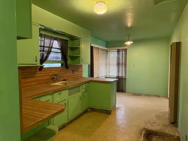 a view of a kitchen with a sink and a large window