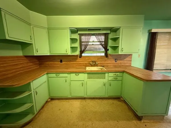 a view of a kitchen with kitchen island a sink and a dishwasher