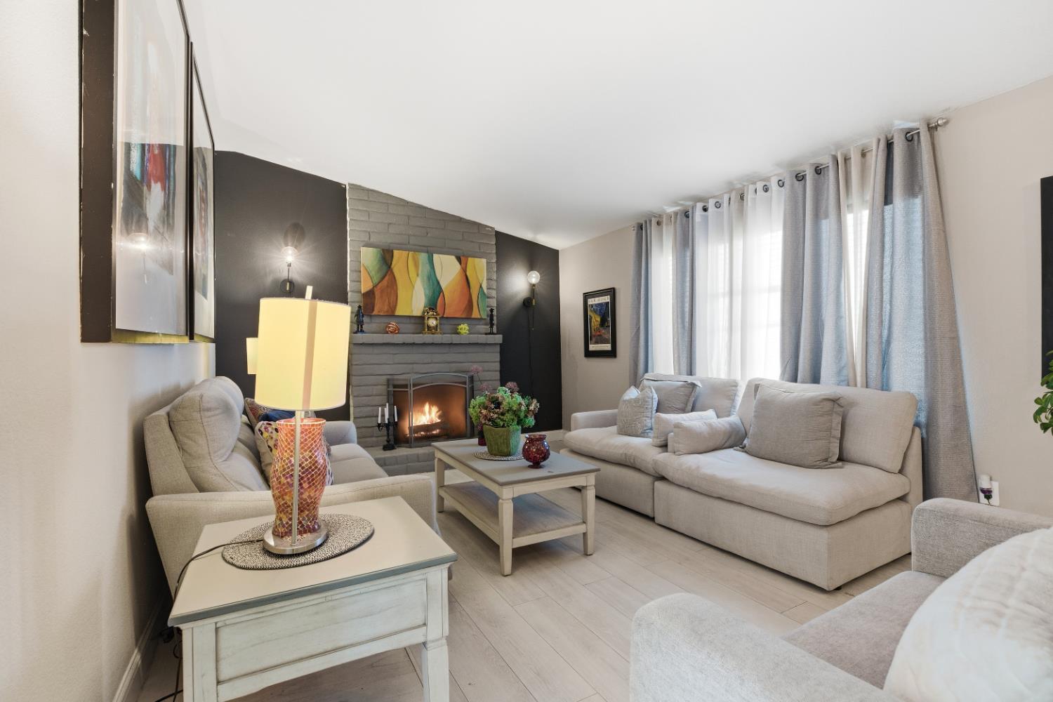 3713 Felkirk Way Modesto, CA 95356 - Photo 2 of 16 a living room with furniture fireplace and a large window